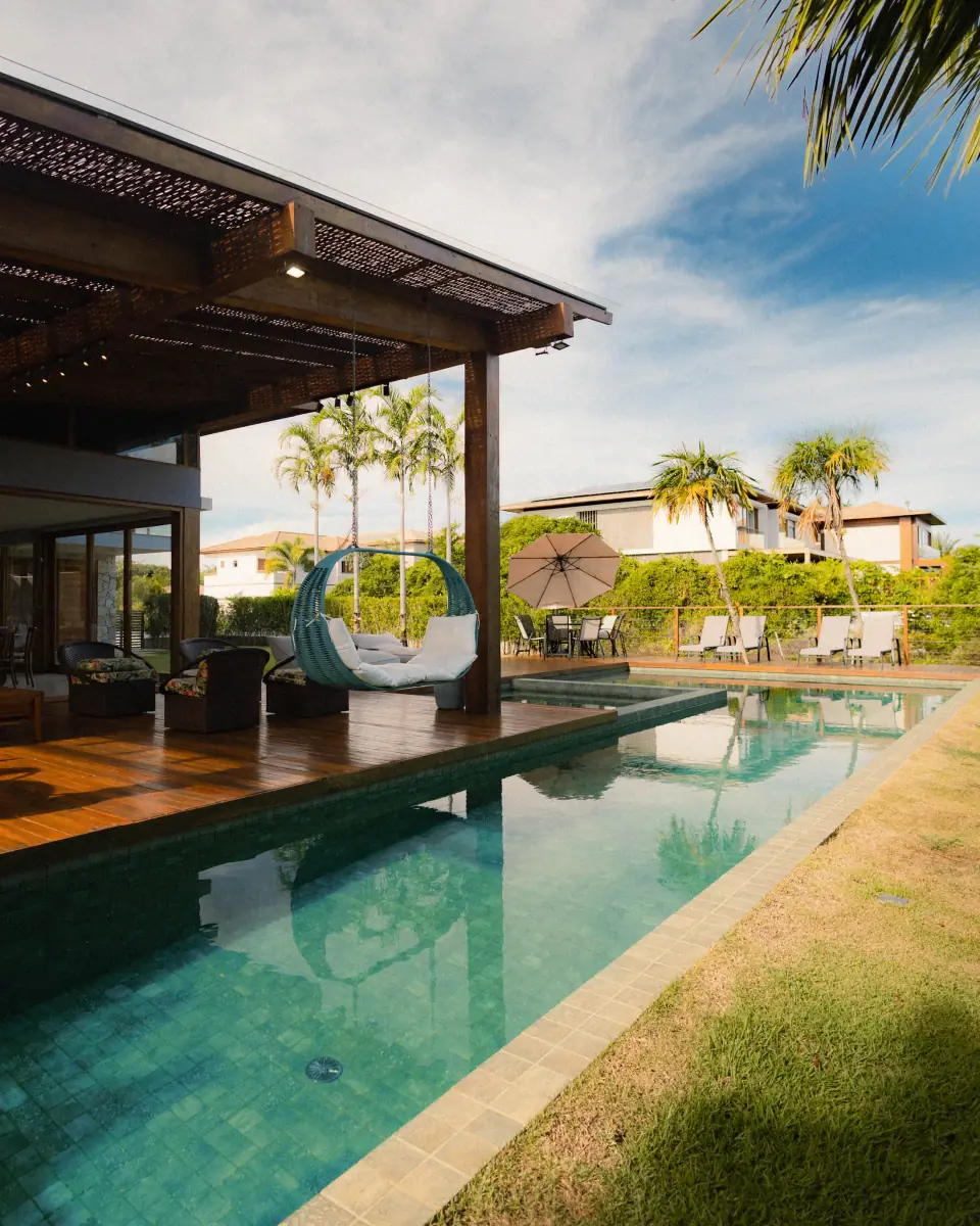 Timber-framed outdoor living space beside a residential swimming pool